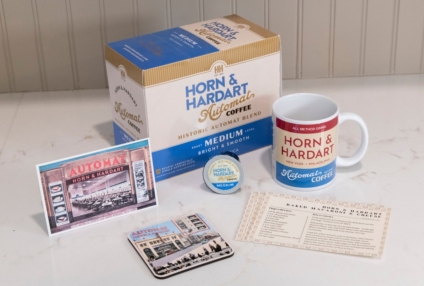 Horn & Hardart coffee packaging with mug, coasters, and product cards on a light surface.
