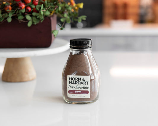 A Horn and Hardart bottle of hot chocolate mix on a table.