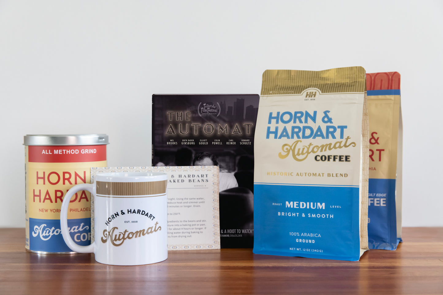 Two bags of coffee, the automat dvd, mug, and a tin