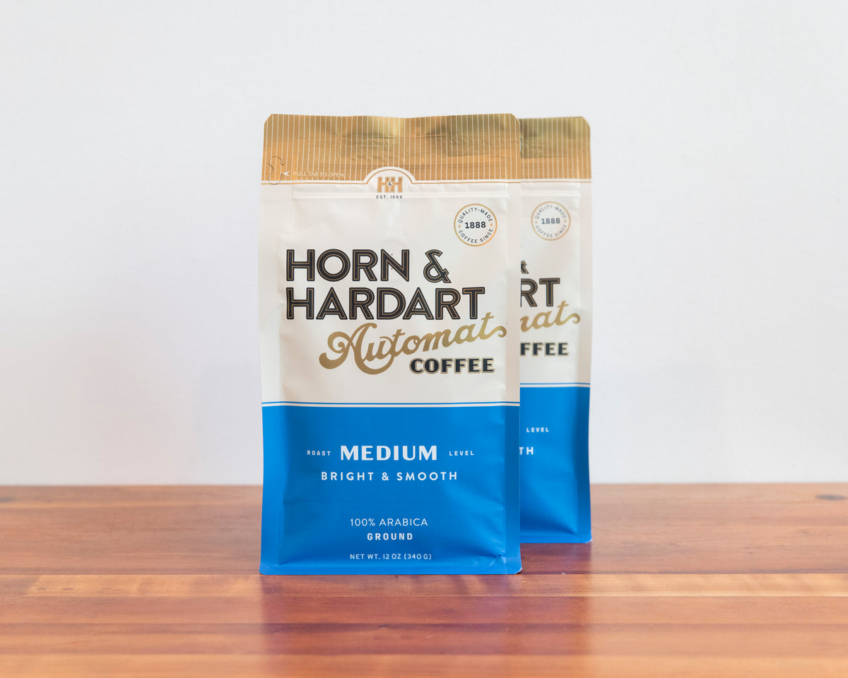 Two bags, Horn & Hardart Medium Roast Automat Coffee bag sitting on a wooden surface