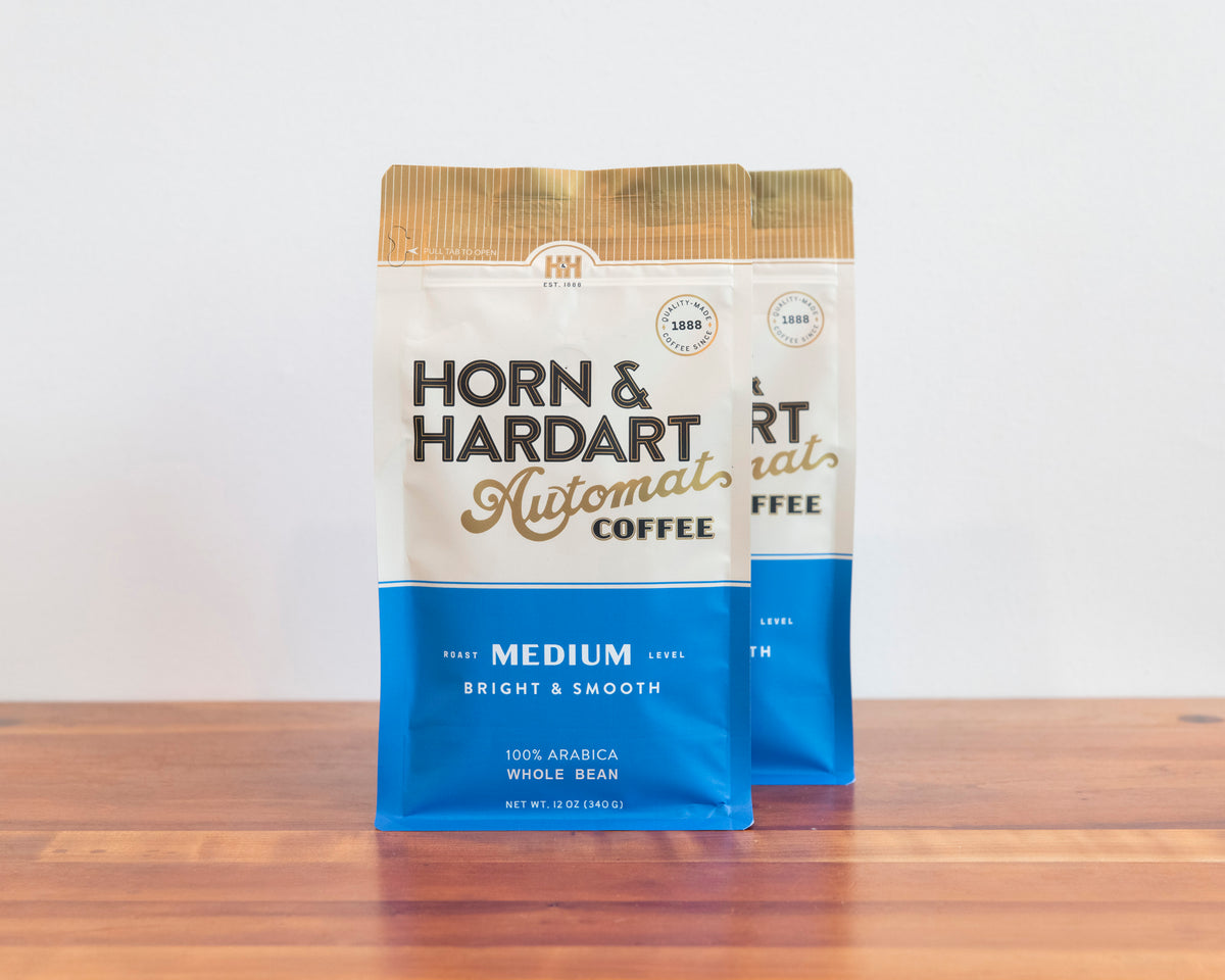 Two bags, Horn & Hardart Medium Roast Automat Coffee bag sitting on a wooden surface