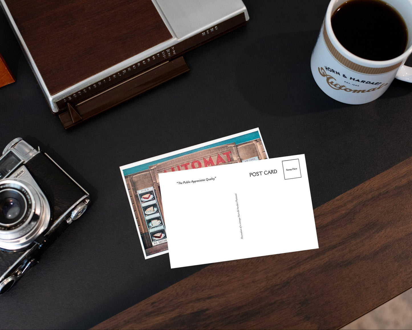 Vintage camera, postcard, and coffee cup on a wooden surface