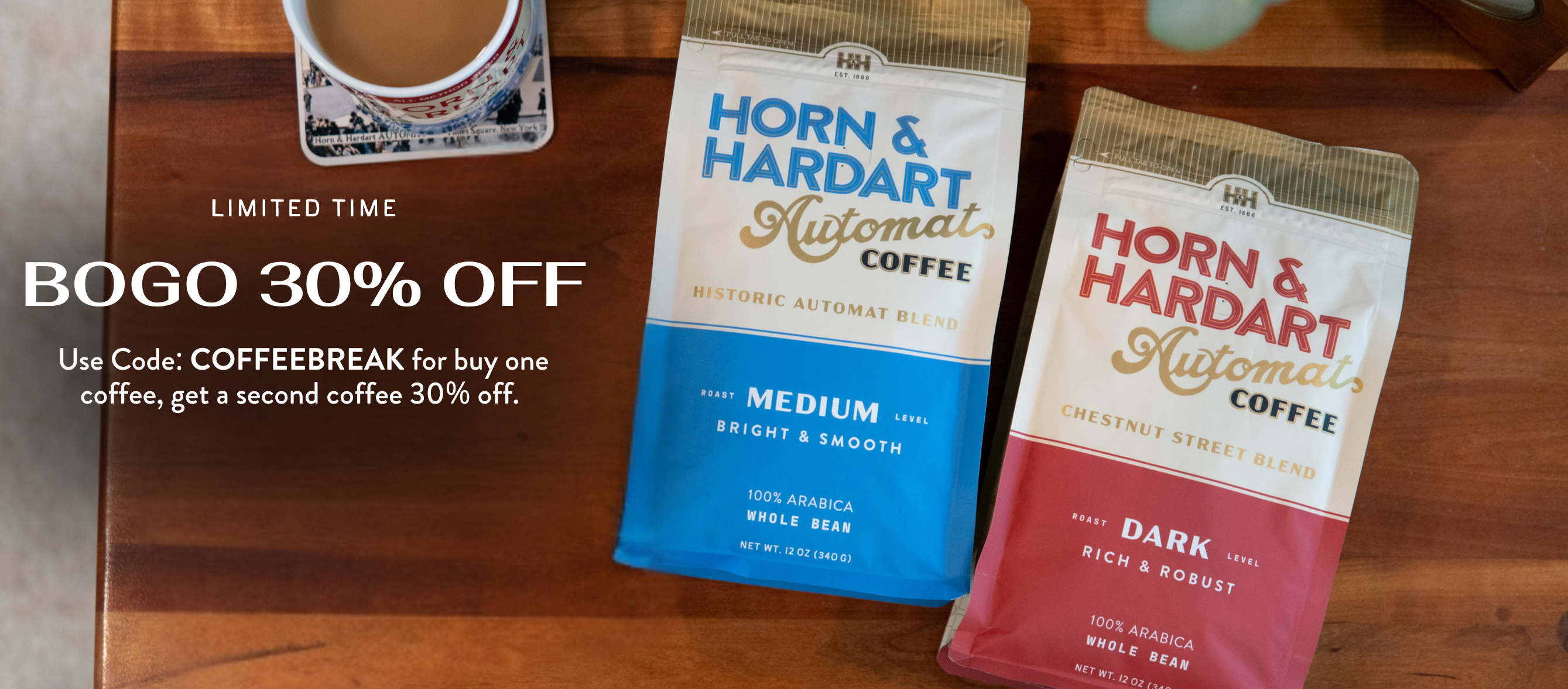 Buy One Coffee, Get a second Coffee 30% Off. Two bags of Horn & Hardart coffee laying on a wooden table. 