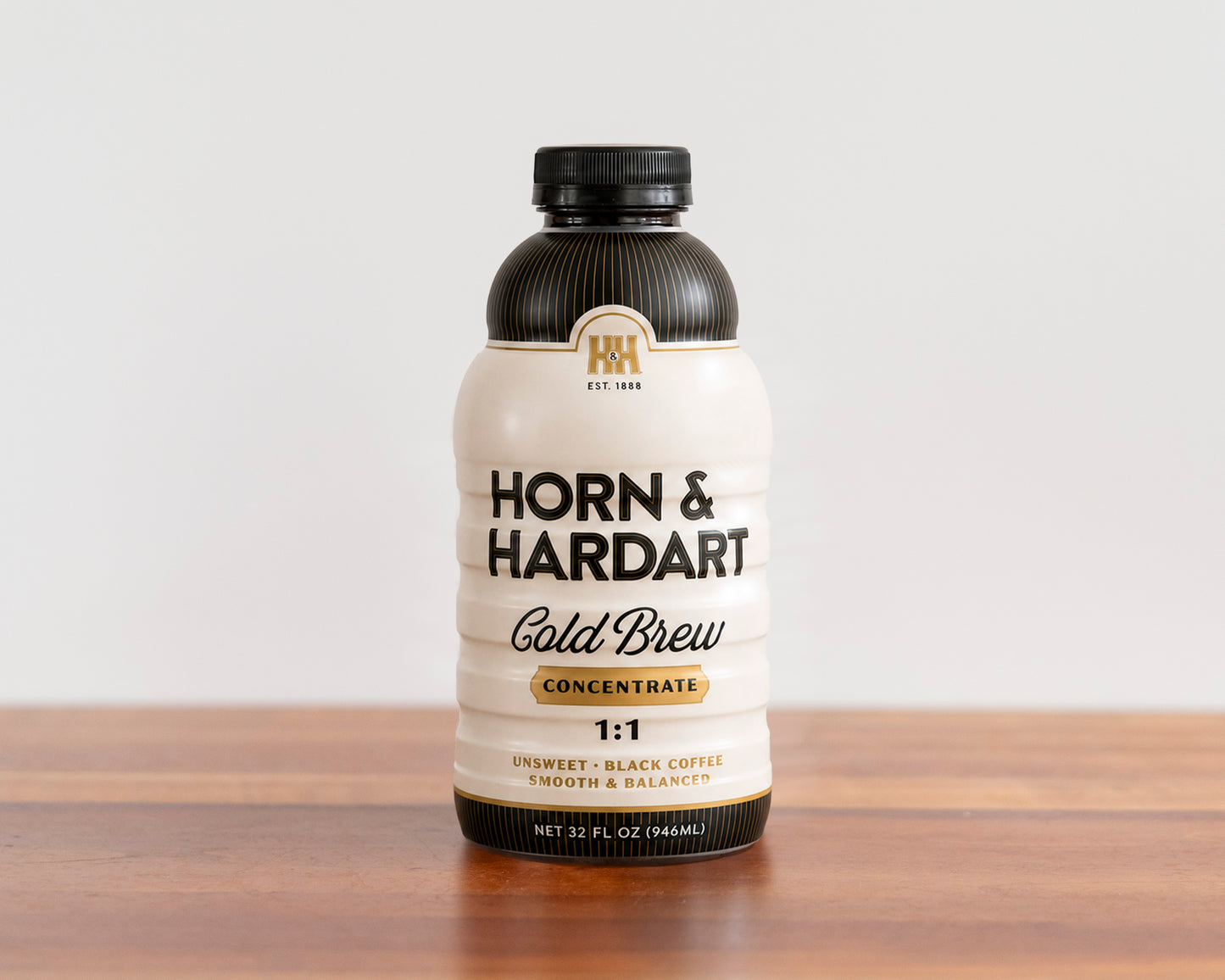 A bottle of Horn and Hardart Cold Brew Concentrate sitting on a wood surface.