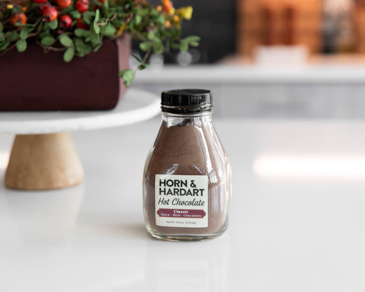 A Horn and Hardart bottle of hot chocolate mix on a table.