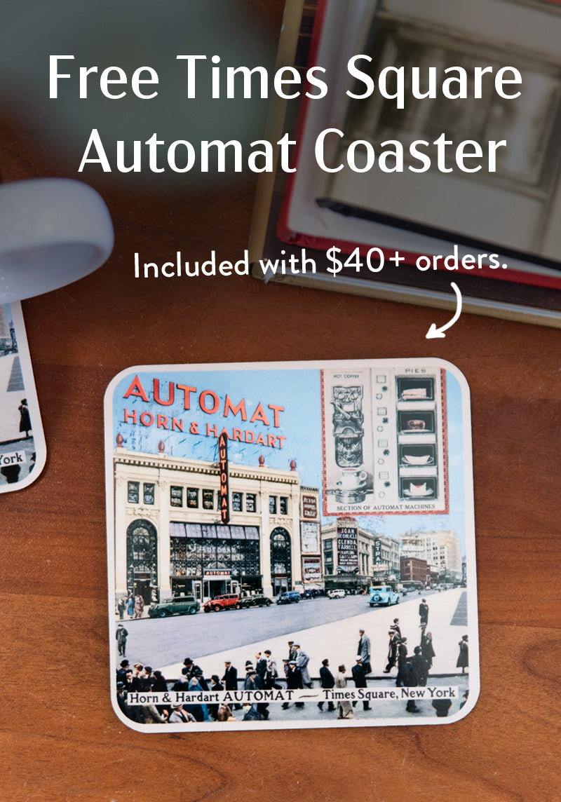 Coaster with Times Square Automat design on a wooden surface, promotional text overlay.