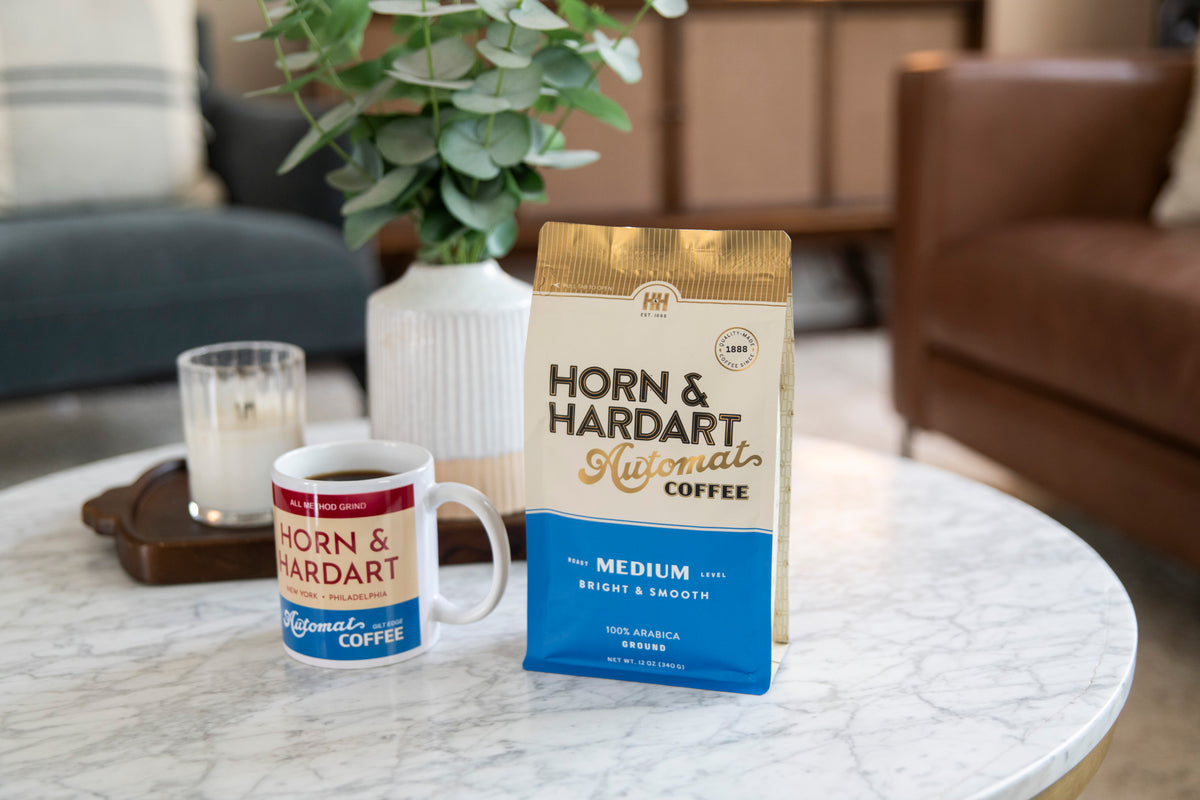 Horn & Hardart Medium Roast Automat Coffee bag sitting on a coffee table next to a mug