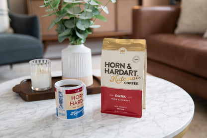 Horn & Hardart Dark Roast Automat Coffee bag sitting on a coffee table next to a mug.