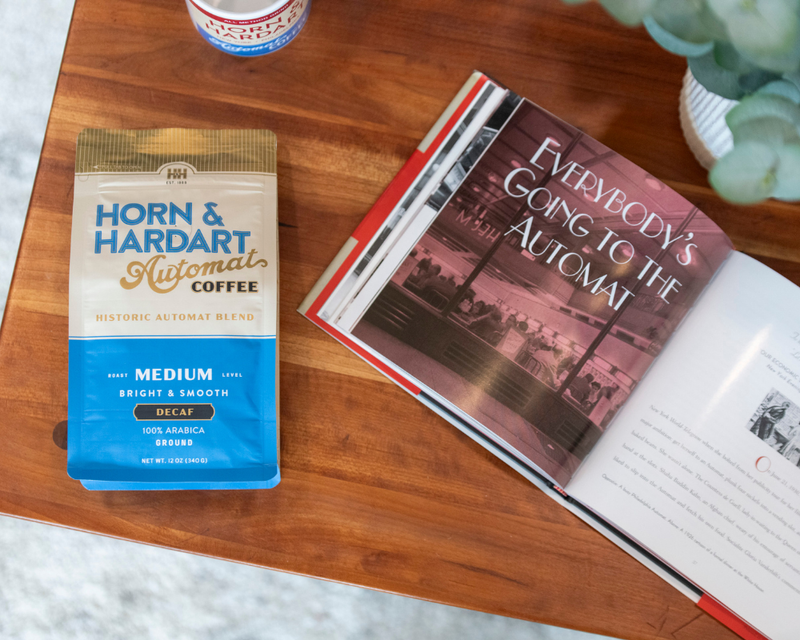 Horn & Hardart coffee package next to an open book on a wooden table