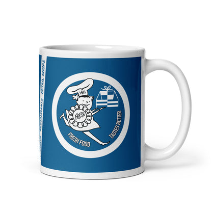 White mug with blue design featuring a cartoon character and text on a white background